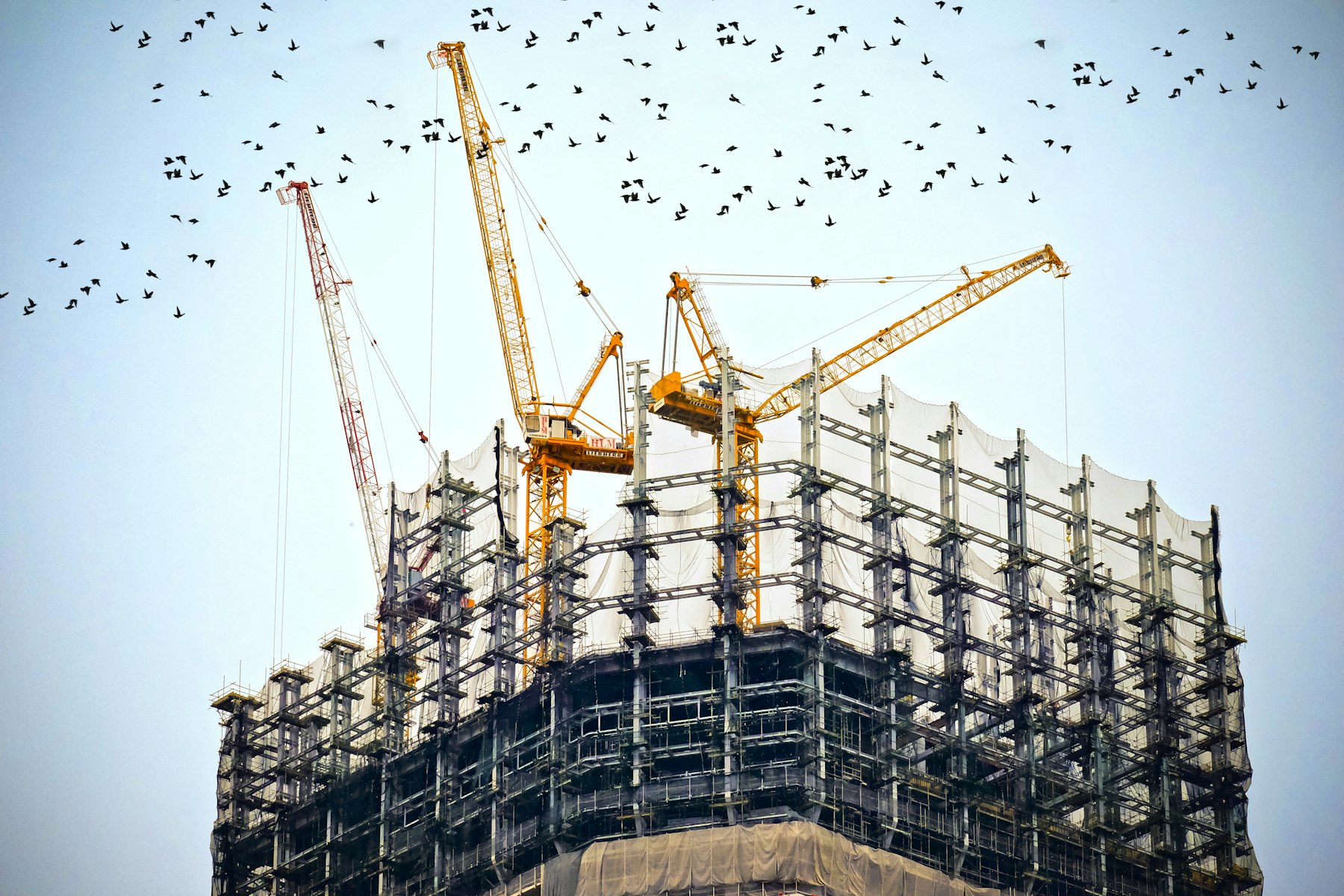 Tower crane against sky on a modern construction site